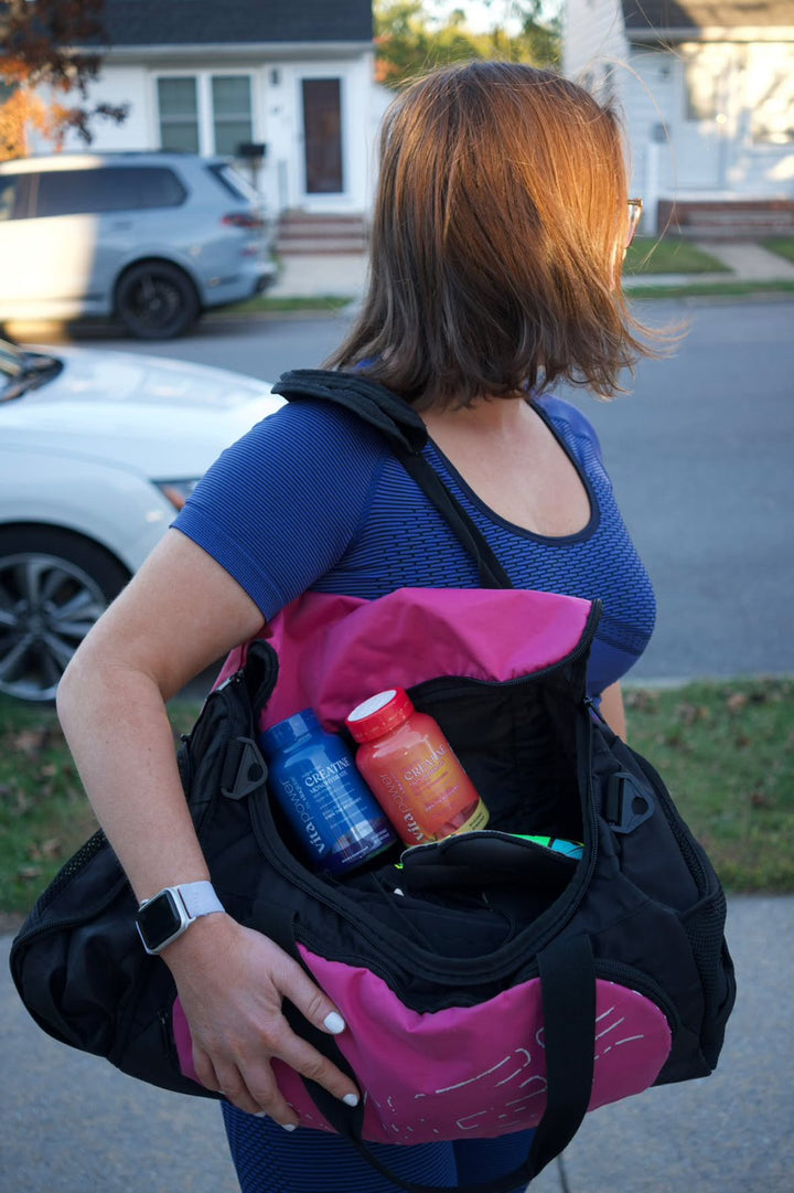 Woman carrying a gym bag packed with Vita Globe creatine gummies