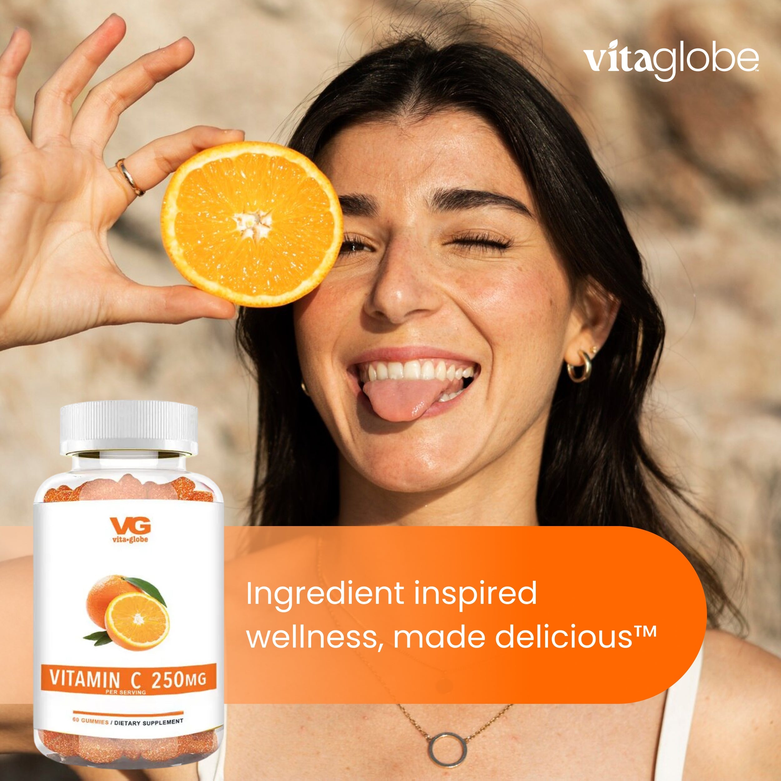 Woman holding an orange with a bottle of Vitaglobe Vitamin C supplement in the foreground.