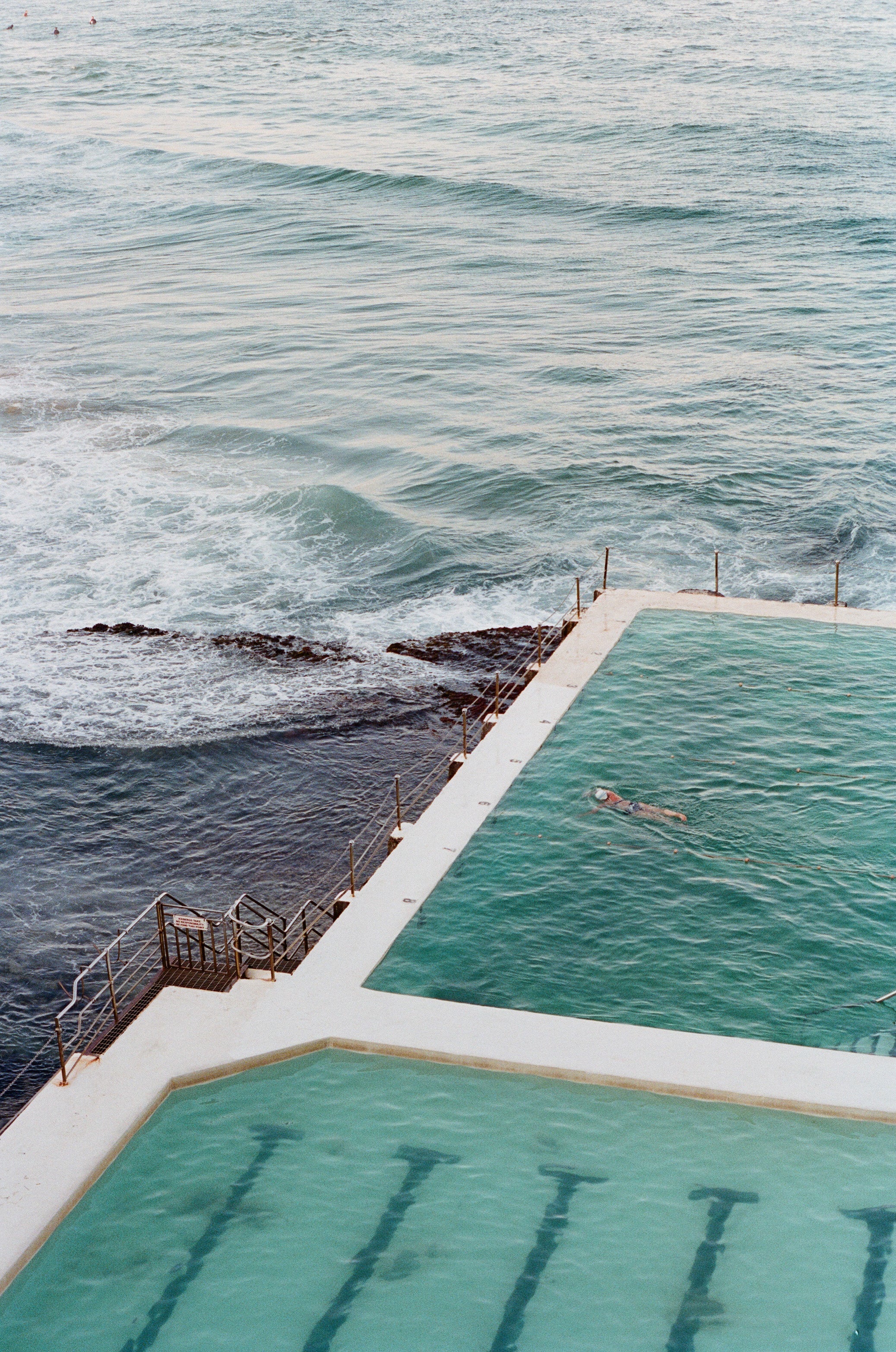 Aerial view of an oceanside swimming pool beside the sea
