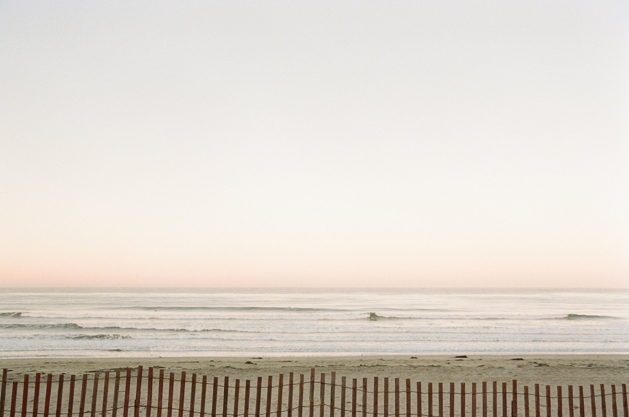 Hazy beach horizon with a dune fence