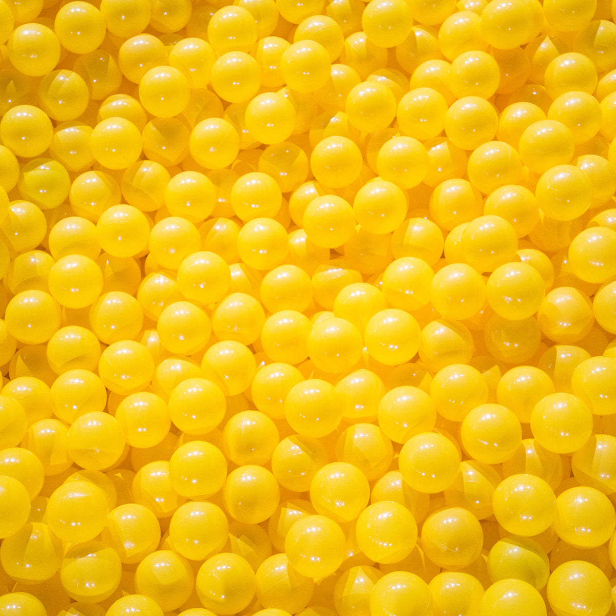Glossy yellow supplement pearls filling the frame