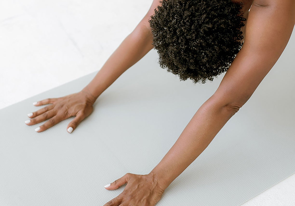 Woman practicing yoga for stress relief and mindfulness—supporting a balanced lifestyle and mental wellness naturally.