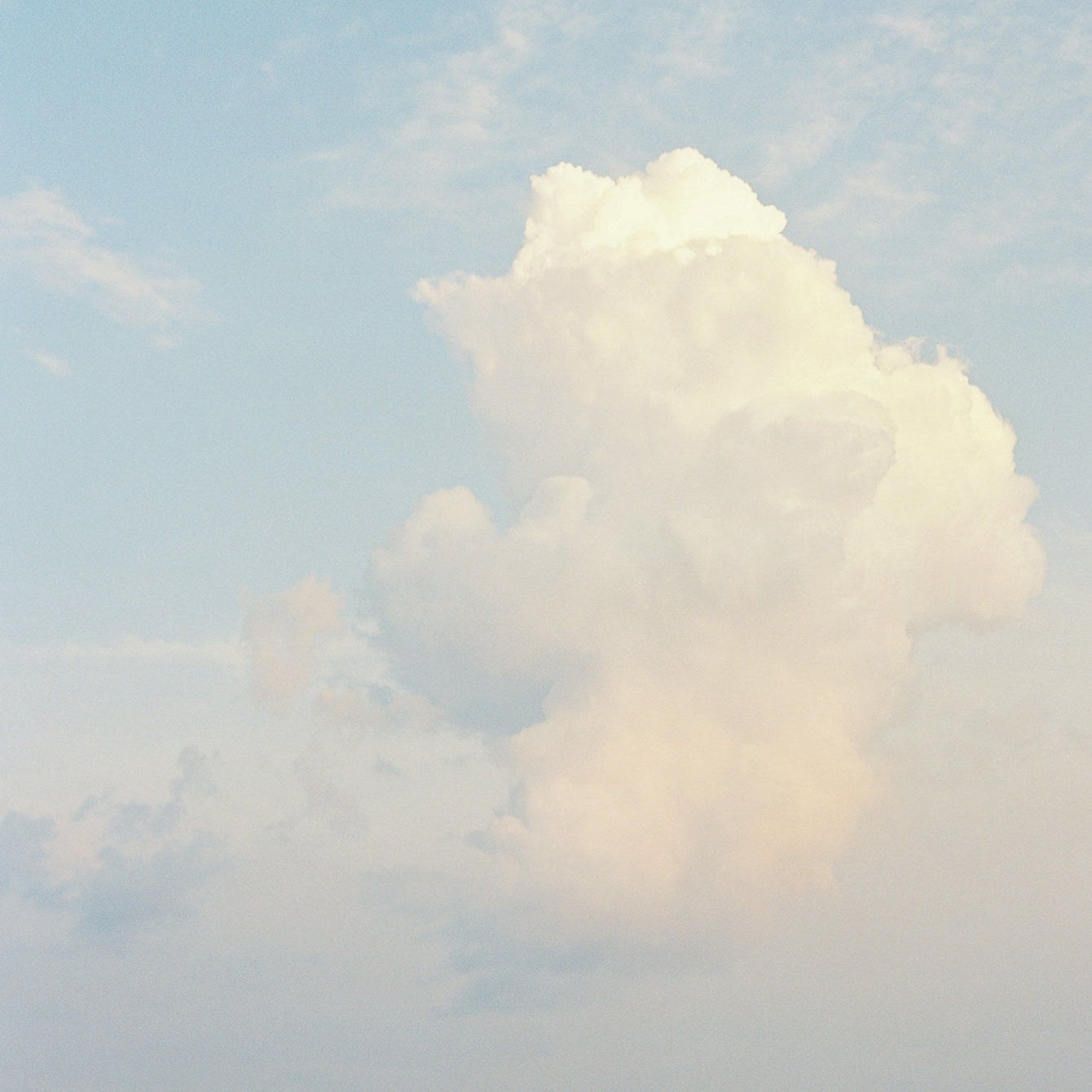 Soft sunlit cloud in a pale blue sky