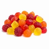 A pile of colorful gummy candies shaped like raspberries and smooth round gummies, in red, orange, yellow, and translucent amber tones, photographed on a clean white background.
