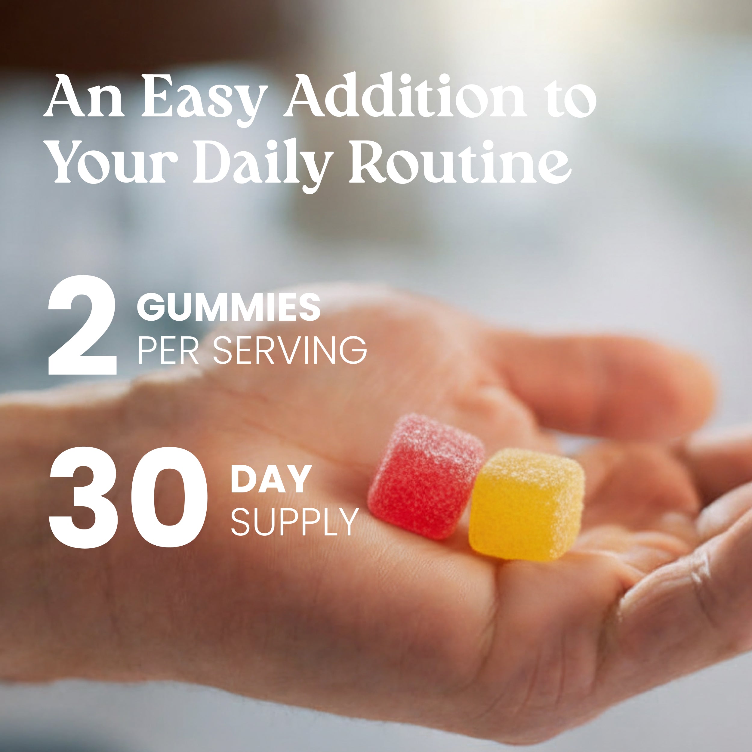 Hand holding two colorful gummies with text about serving size and supply duration.