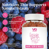 A bottle of VG Vita-Globe Hair, Skin & Nails supplement placed in front of a close-up background of raspberries and blueberries. The bottle has a white label with pink text and graphics.