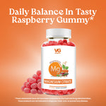 Vita Globe Magnesium Citrate gummy supplement bottle filled with red raspberry-flavored gummies on an orange background, with loose gummies displayed beside the bottle and product label visible.