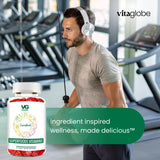 Man exercising in a gym with Vitaglobe superfoods vitamins bottle in foreground
