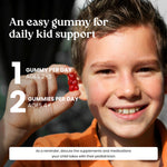 A smiling young boy in an orange shirt holds a small red gummy in his hand, with large marketing text reading 'An easy gummy for daily kid support' and usage recommendations. This is a lifestyle promotional image rather than a clean product shot.