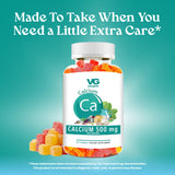 Bottle of VG Calcium gummies with a teal background and text about extra care.