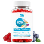 A bottle of VG Biotin 5000mcg gummies with a blue and white label featuring raspberries and blueberries, white cap, on a white background.