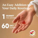 Promotional graphic for an apple-flavored gummy supplement. It features a close-up of a human hand holding a single red gummy, with text overlays reading 'An Easy Addition to Your Daily Routine', '1 GUMMY PER SERVING', and '60 DAY SUPPLY'.