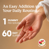 Promotional graphic for an apple-flavored gummy supplement. It features a close-up of a human hand holding a single red gummy, with text overlays reading 'An Easy Addition to Your Daily Routine', '1 GUMMY PER SERVING', and '60 DAY SUPPLY'.