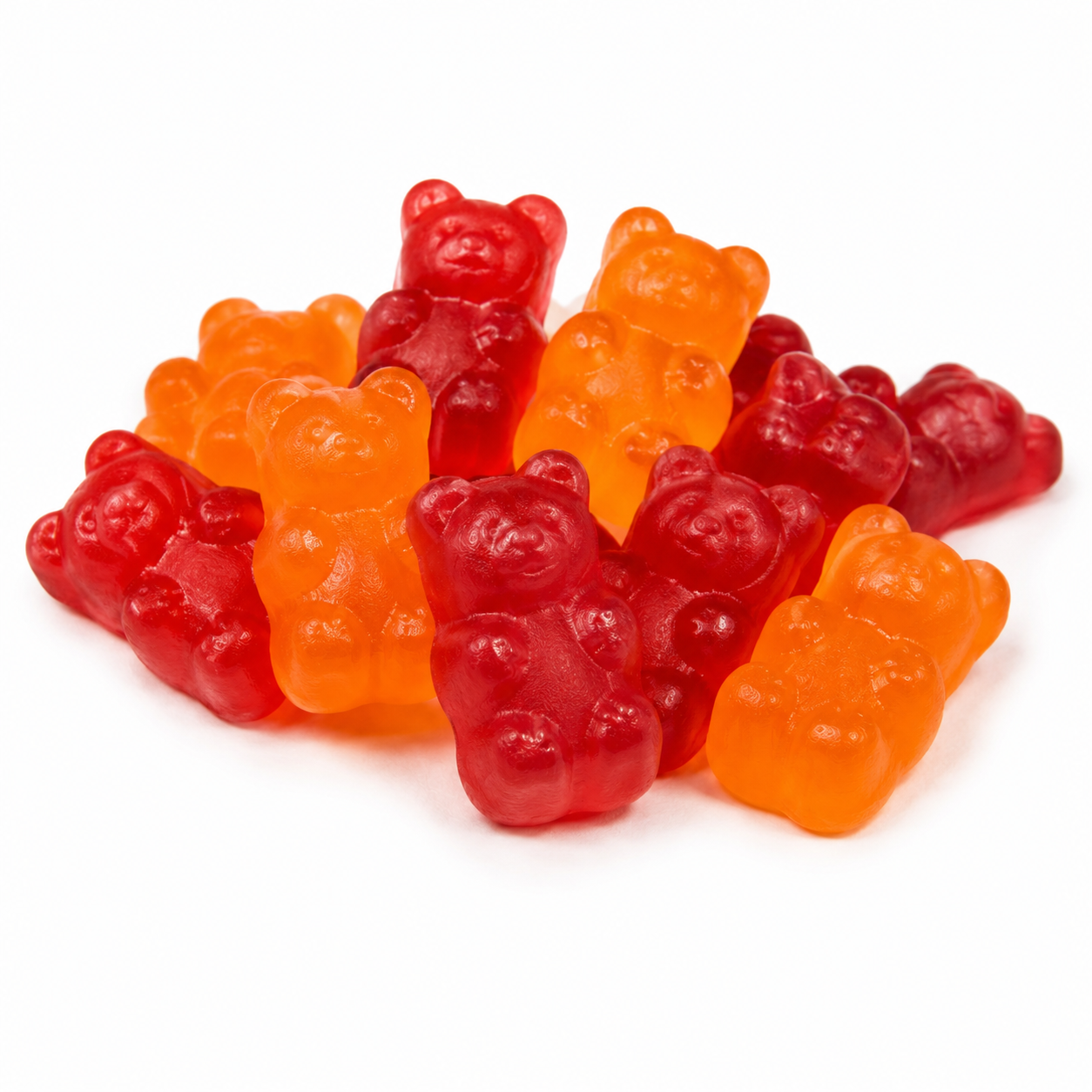 A pile of translucent gummy bear candies in red and orange, photographed on a clean white background.