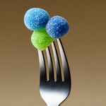 VitaPower Sugar-Free Creatine gummies in blue and green on a fork
