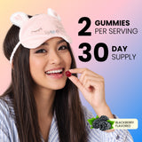 Woman in sleep mask holding a blackberry-flavored melatonin gummy: 2 gummies per serving, 30 day supply