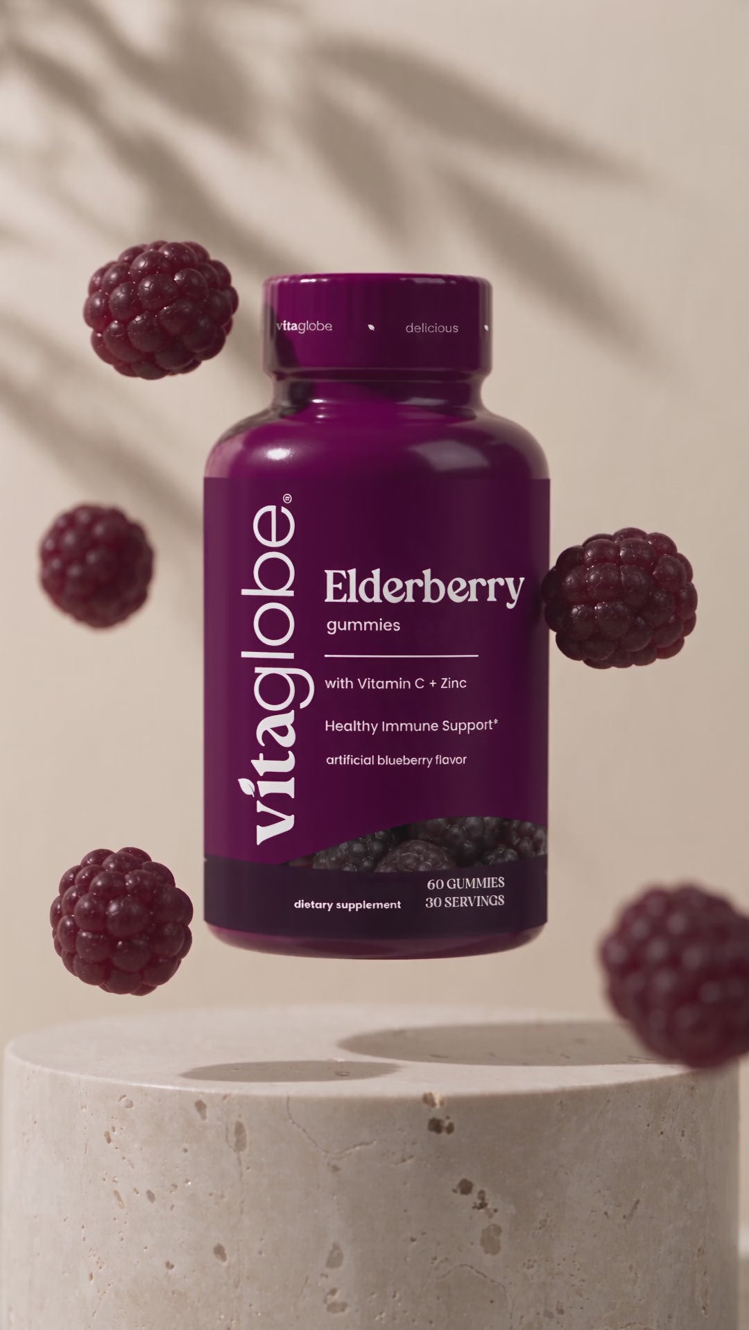 Vita Globe Elderberry gummies with Vitamin C and Zinc bottle floating with berry gummies
