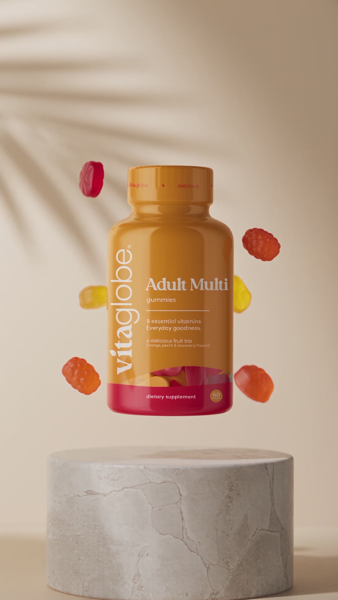 Vita Globe Adult Multi gummies bottle floating with fruit gummies