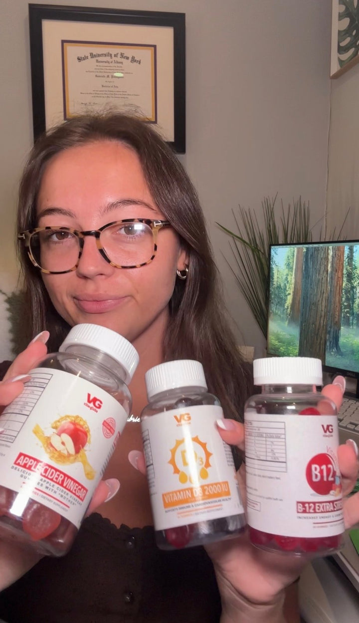 Woman holding Vita Globe apple cider vinegar, vitamin D3 and B12 gummies