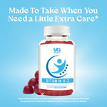 Promotional graphic for VG Vitamin K2 gummies reading 'Made To Take When You Need a Little Extra Care' on a blue background.