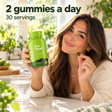 Woman holding Vita Globe Sea Moss gummies in a sunny kitchen: 2 gummies a day, 30 servings